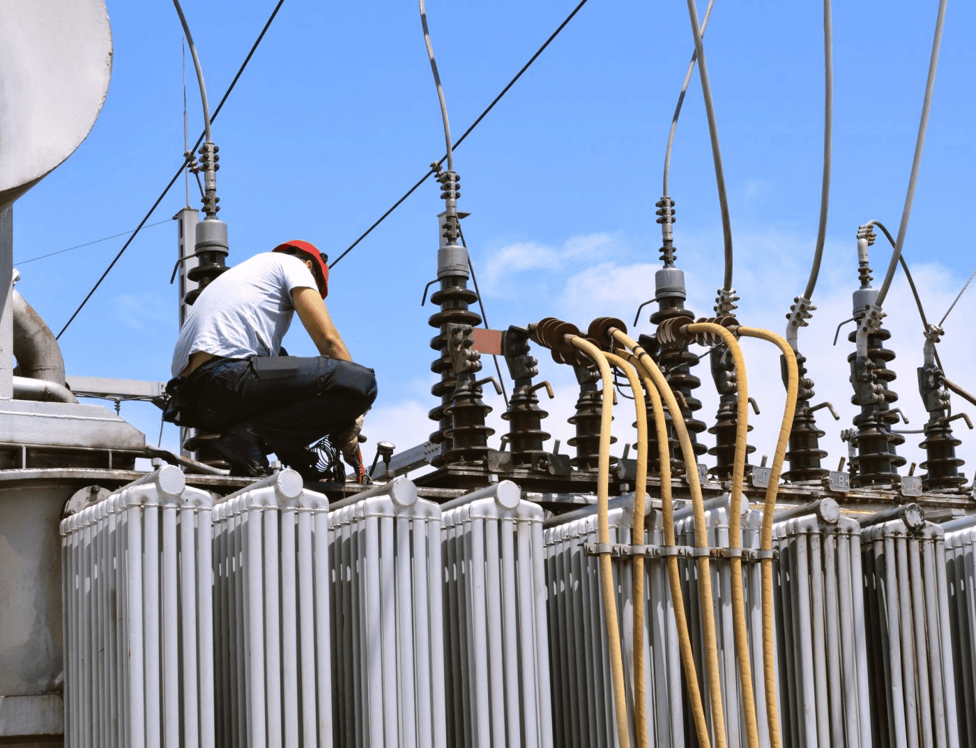 Definite Electric technician servicing high-voltage transformer and distribution equipment in Houston