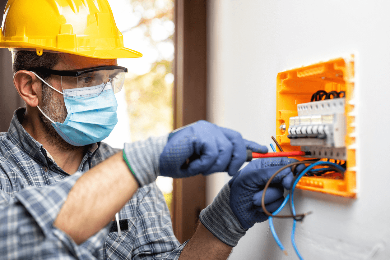 Licensed electrician installing and wiring a breaker panel